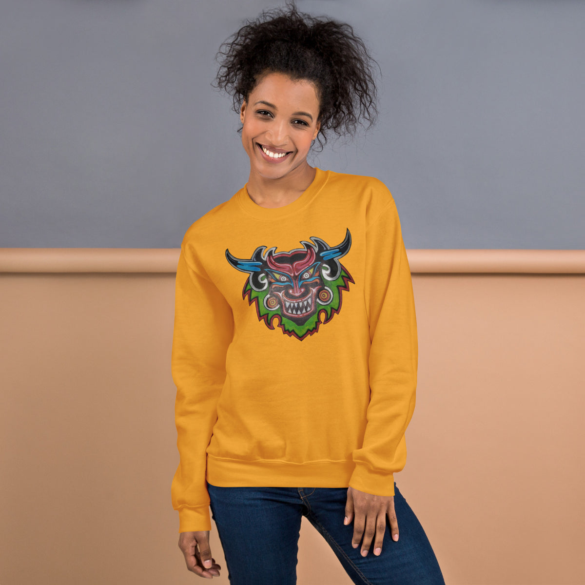 Gold unisex crewneck sweatshirt with hand-drawn Dancing Demon folk art by Bareta Fina Designs