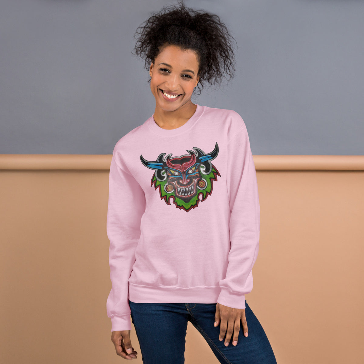 Light pink unisex crewneck sweatshirt with hand-drawn Dancing Demon folk art by Bareta Fina Designs