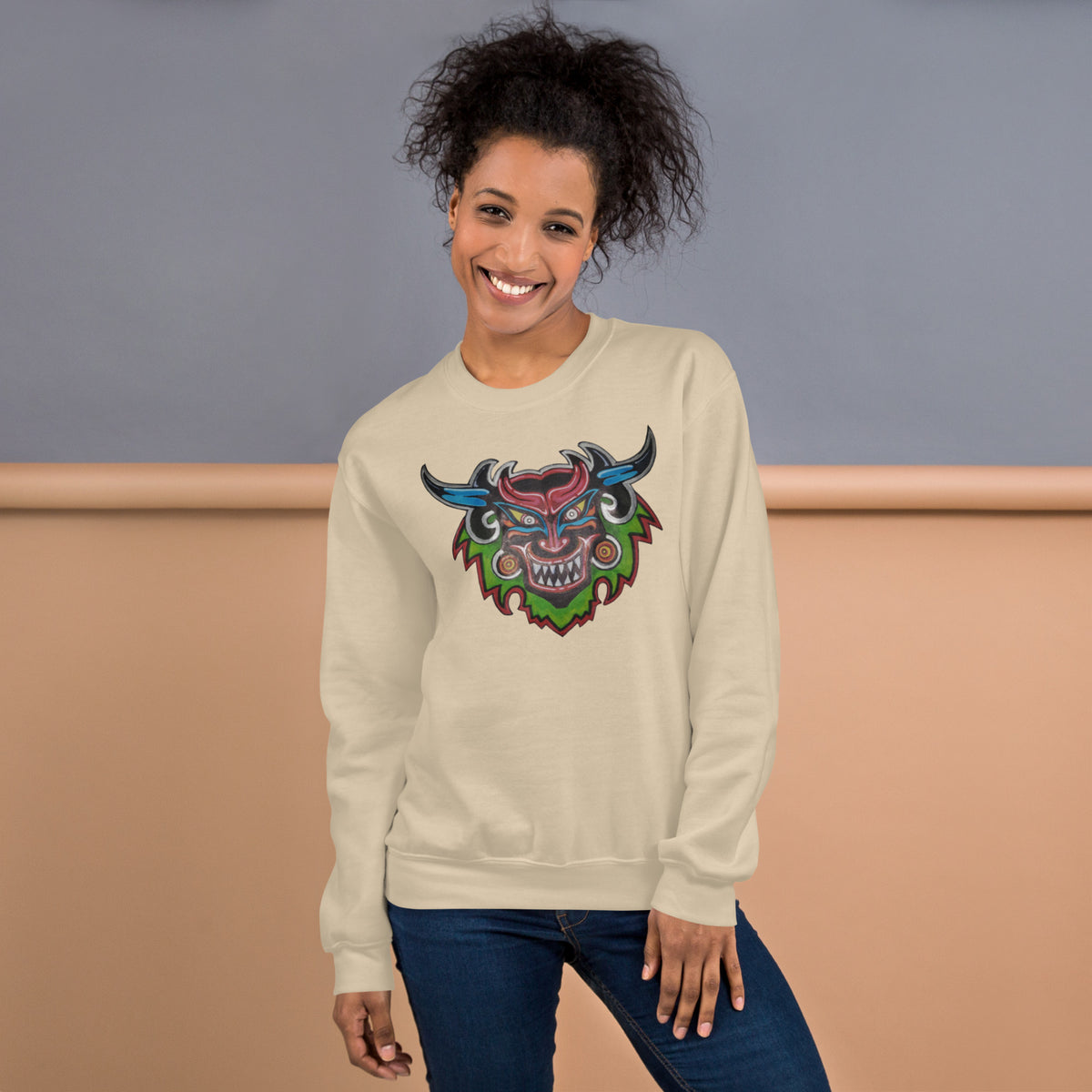 Sand unisex crewneck sweatshirt with hand-drawn Dancing Demon folk art by Bareta Fina Designs