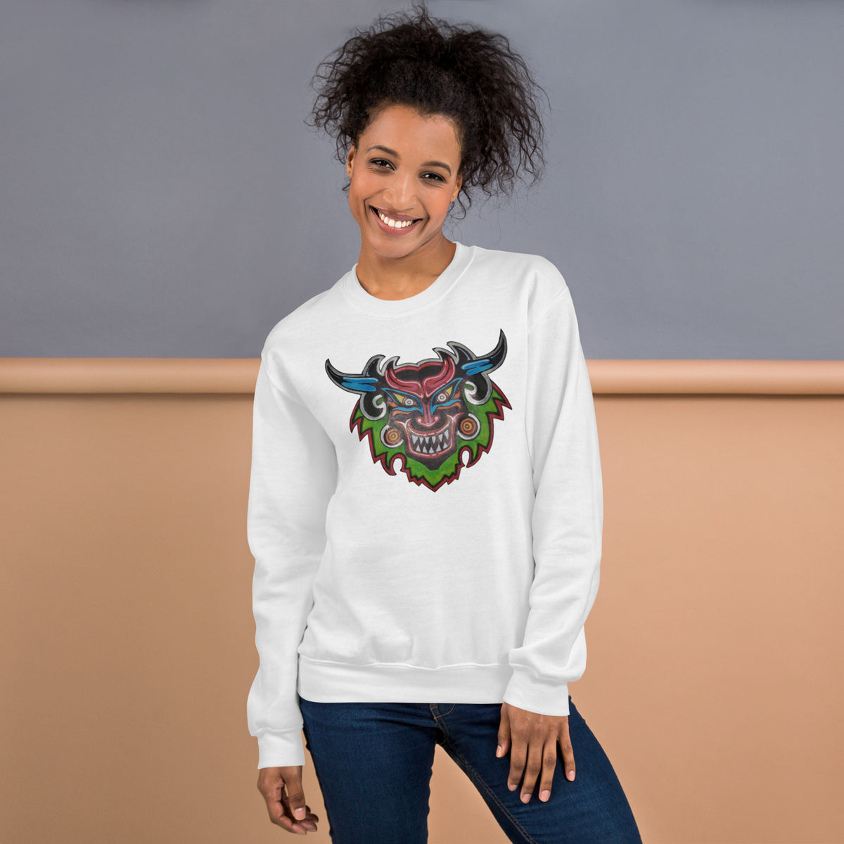 White unisex crewneck sweatshirt with hand-drawn Dancing Demon folk art by Bareta Fina Designs