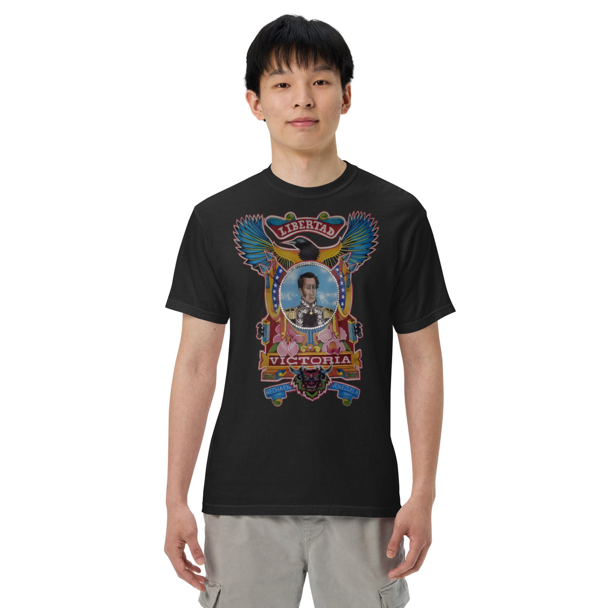 Black unisex heavyweight tee with hand-drawn Simón Bolívar-inspired art – El Libertador heavyweight tee by Bareta Fina Designs