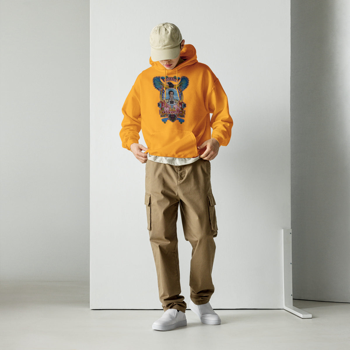 Gold unisex hoodie with hand-drawn Simón Bolívar-inspired art – El Libertador hoodie by Bareta Fina Designs