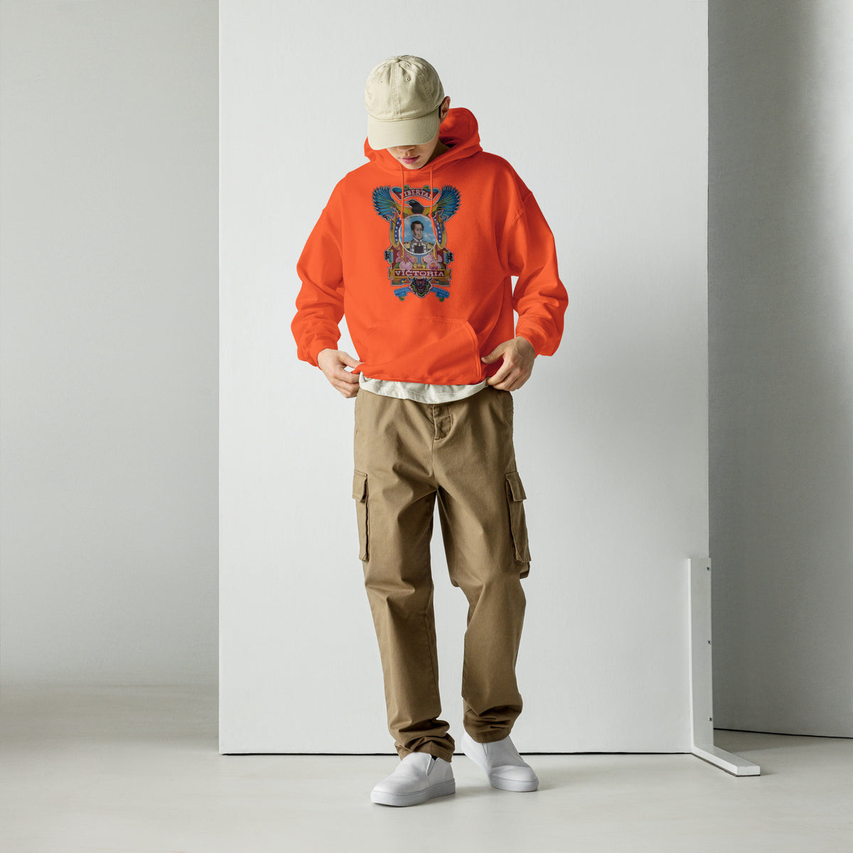 Orange unisex hoodie with hand-drawn Simón Bolívar-inspired art – El Libertador hoodie by Bareta Fina Designs